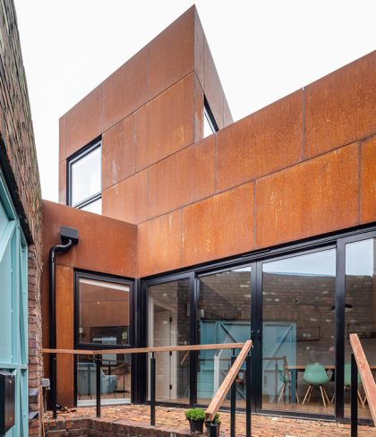 Tuck the Corten Steel House and Courtyard behind Old Brick Wall